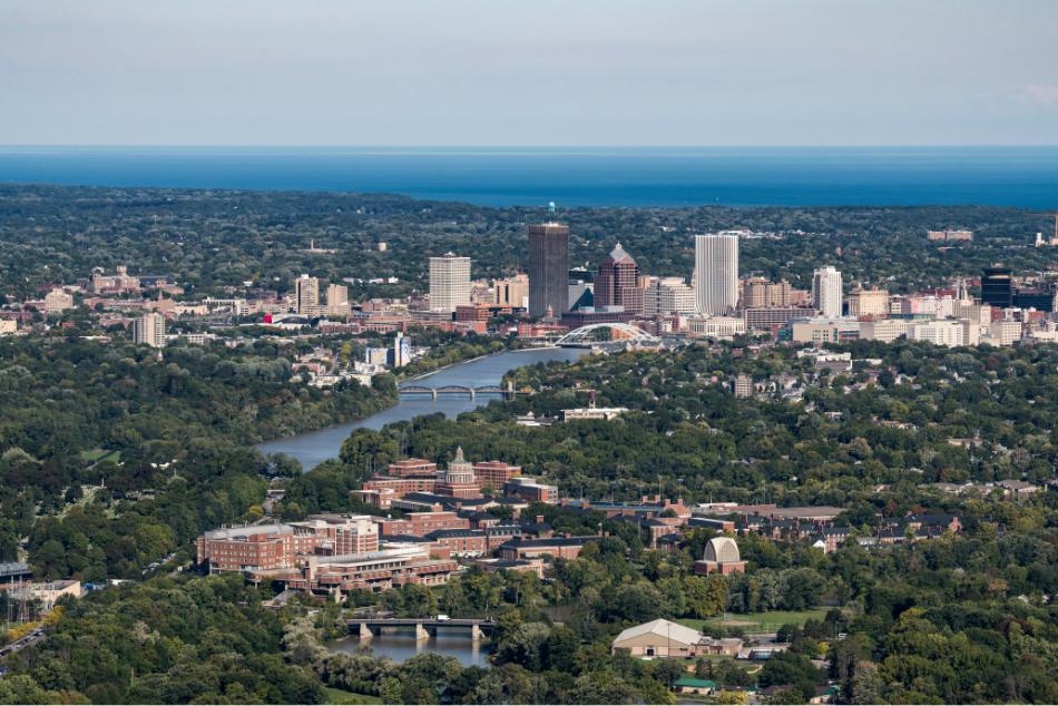 Aerial image of University of Rochester with Rochester skyline in background