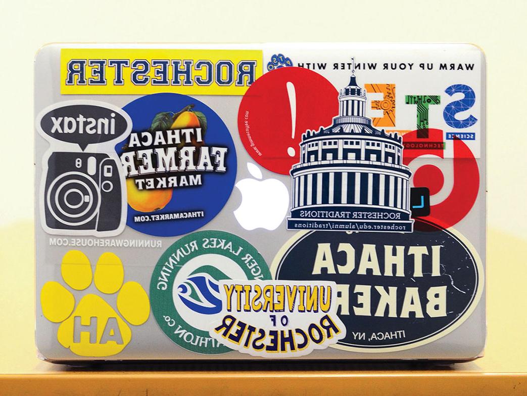 laptop covered in stickers with Rochester themes.